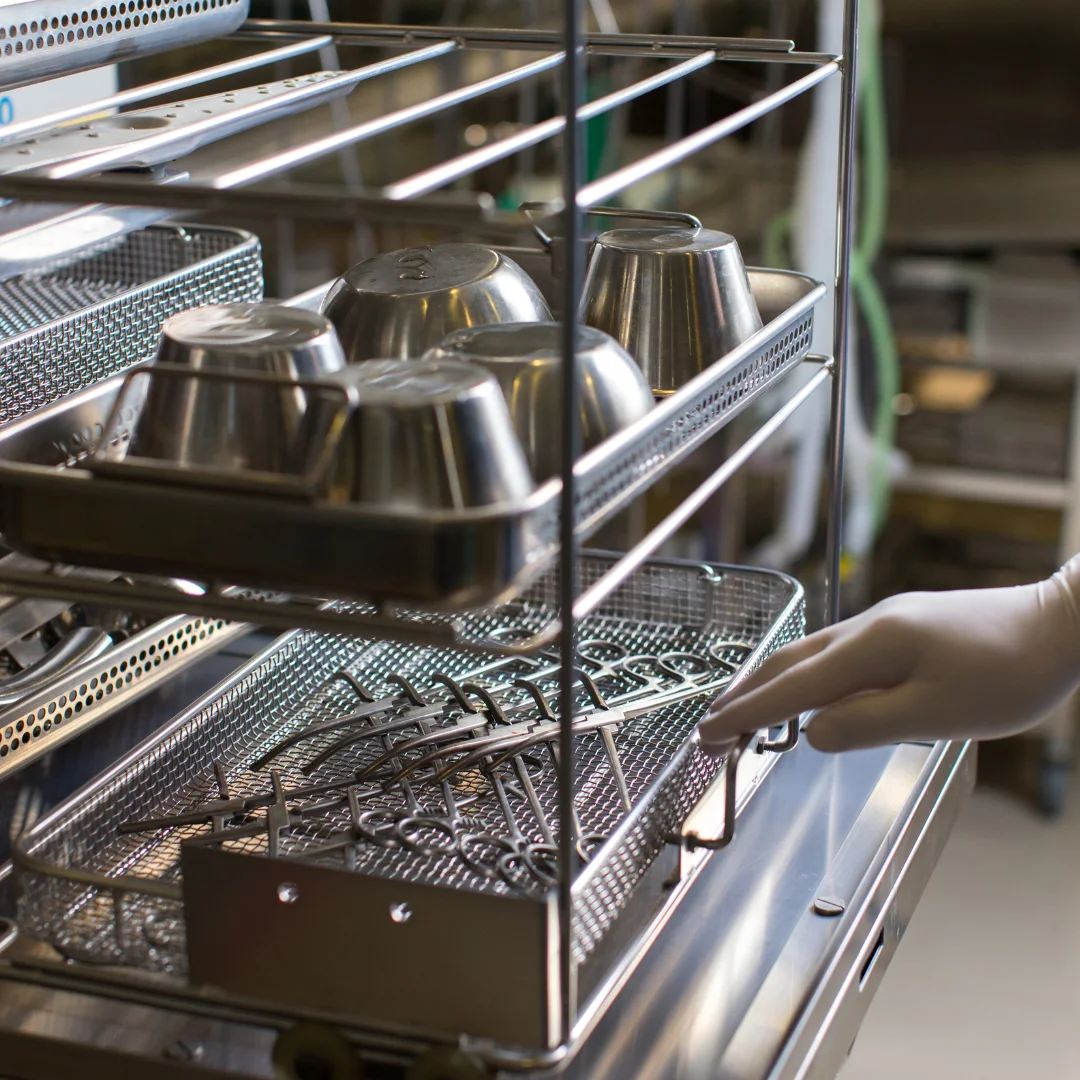 Sterilised surgical instruments arranged on metal trays in a hospital sterilisation unit.